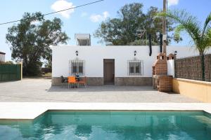a house with a swimming pool in front of it at Villa Montenmedio 2 in El Soto