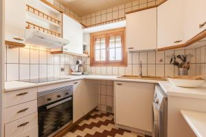 a kitchen with white appliances and a checkered floor at Sant Pere in Mataró