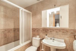 a bathroom with a toilet and a sink and a mirror at El Tejado in Maluenda +20 photos