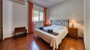 a bedroom with a bed and a desk and a window at Costacabana - Villa Alba in Lloret de Mar +11 photos
