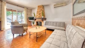 a living room with a couch and a table at Costacabana - Villa Alba in Lloret de Mar