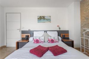 a bedroom with a bed with two red towels on it at Bocal De Bages - Chez l'habitant in Bages +34 photos