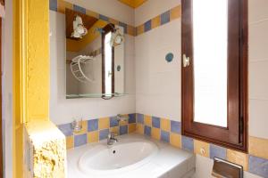 a bathroom with a sink and a mirror at Marina de Sant Ambroggio in Lumio