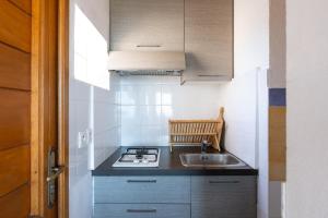 a small kitchen with a sink and a stove at Marina de Sant Ambroggio in Lumio +12 photos