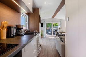 a kitchen with a counter and a living room at Haus Waldblick in Saal