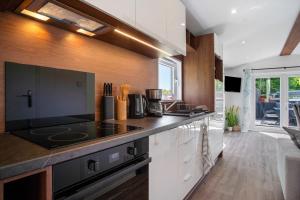 a kitchen with a stove and a counter top at Haus Waldblick in Saal +17 photos