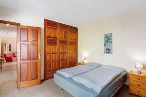 a bedroom with a bed and a wooden door at Moijama 4 in Los Llanos de Aridane +19 photos