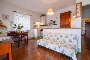 a living room with a couch and a table at Appartamento Glicine in Radicofani