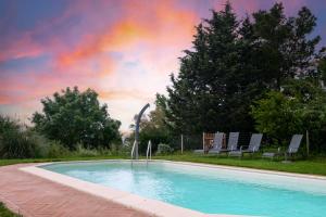 a swimming pool with a rainbow in the sky at Appartamento Glicine in Radicofani