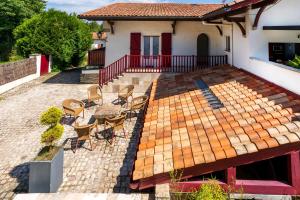 a patio with chairs and a table on a house at Appartement, 2 à 4 pers in Urrugne +9 photos