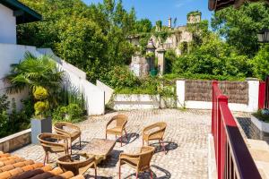 a group of chairs and tables on a patio at Appartement, 2 à 4 pers in Urrugne