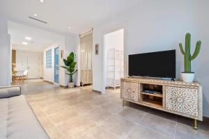 a living room with a flat screen tv on a entertainment center at Mabicarent Playa 1 in Calafell