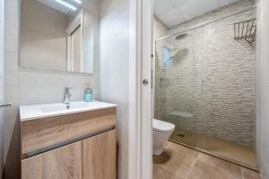 a bathroom with a sink and a toilet at Mabicarent Playa 1 in Calafell +14 photos