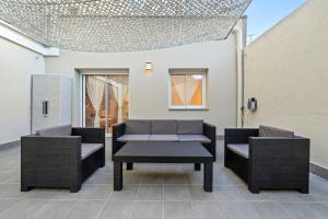 two chairs and a table on a patio at Mabicarent Playa 1 in Calafell