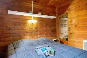 a bedroom with a bed in a wooden cabin at Chalet prestige 19 piscine partagée in Saint-Gervais