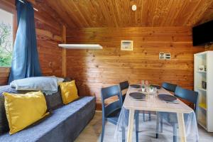 a dining room with a couch and a table at Chalet prestige 19 piscine partagée in Saint-Gervais