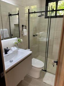 a bathroom with a shower and a toilet and a sink at Casa Makuira 2 in El Valle de Antón +32 photos