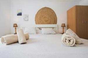 a bedroom with a white bed with two towels on it at El Cotillo Mar Beach in El Cotillo