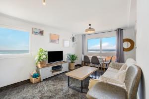 a living room with a couch and a tv at El Cotillo Mar Beach in El Cotillo
