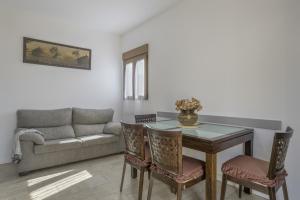 a living room with a table and a couch at Casa Sofia in Conil de la Frontera