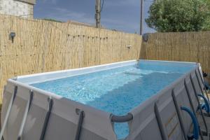 a hot tub in front of a wooden fence at Casa Sofia in Conil de la Frontera
