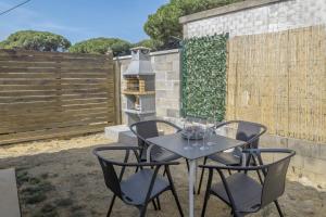 a table and chairs on a patio with a fence at Casa Sofia in Conil de la Frontera
