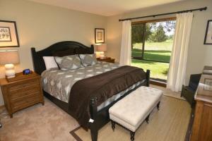 a bedroom with a large bed and a window at 81 Meadow Lane in Sunriver +16 photos