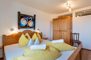 a bedroom with a bed with two pillows at Gunzhof in Kastelruth