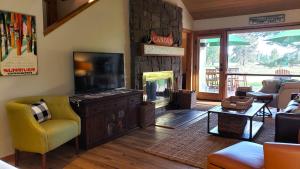a living room with a television and a fireplace at 81 Meadow Lane in Sunriver