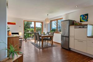 a kitchen and dining room with a table and chairs at Gunzhof in Kastelruth