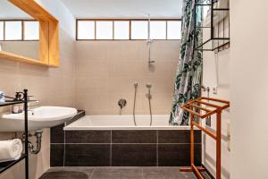 a bathroom with a bath tub and a sink at Gunzhof in Kastelruth +22 photos