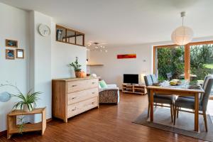 a living room with a table and a desk at Gunzhof in Kastelruth