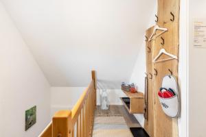 a room with a stairway with a wooden wall at Ferienwohnung zum Heubalken in Schmallenberg +18 photos