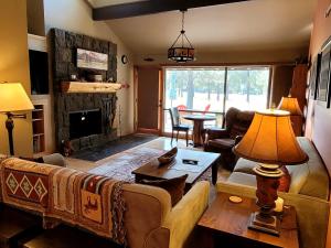a living room with a couch and a fireplace at 89 Meadow House in Sunriver