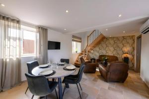 a living room with a table and chairs at L'Ascalon in Saint-Sauveur-le-Vicomte