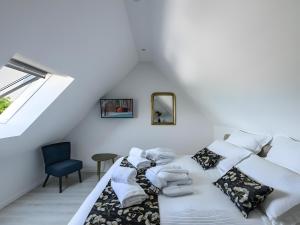 a white room with two beds and a chair at L'Ascalon in Saint-Sauveur-le-Vicomte +19 photos