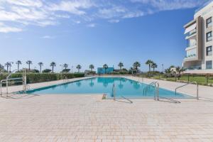 a swimming pool in the middle of a building at Los Flamencos in Isla Canela
