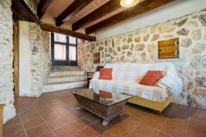 a living room with a couch and a table at Lo paller in Perelló +33 photos