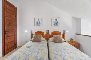 a bedroom with two beds and a wooden door at Santiago Beach in Costa Adeje +17 photos