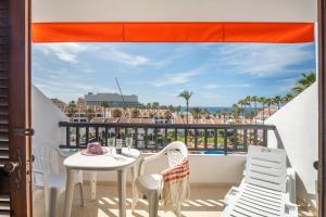 a balcony with a table and chairs and a view of the ocean at Santiago Beach in Costa Adeje