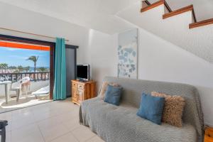 a living room with a couch and a view of the ocean at Santiago Beach in Costa Adeje