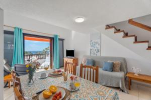 a living room with a table and a dining room at Santiago Beach in Costa Adeje