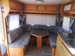 a couch and a table in the back of a rv at Roca Caravan in Estepona
