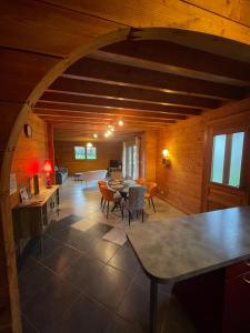 a living room with a table and chairs at Le Chalet de Noblat in Saint-Léonard-de-Noblat