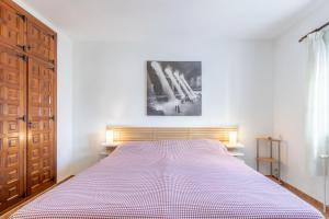 a bedroom with a bed and a wooden door at Fantastisic villa - Great location in Moraira +20 photos