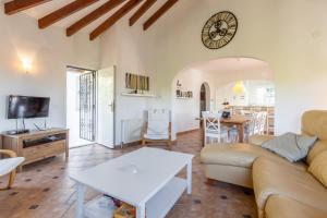 a living room with a couch and a table at Fantastisic villa - Great location in Moraira