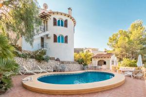 a villa with a swimming pool in front of a house at Fantastisic villa - Great location in Moraira