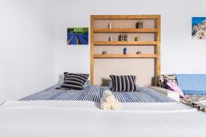 a bedroom with two beds with striped pillows at Casa Suárez in Tuineje