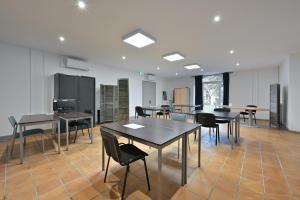 an empty room with tables and chairs in it at Villa Milady 2 in Salies-du-Salat
