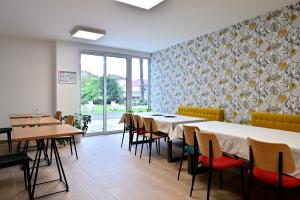 a dining room with tables and chairs and a patterned wall at Villa Milady 2 in Salies-du-Salat